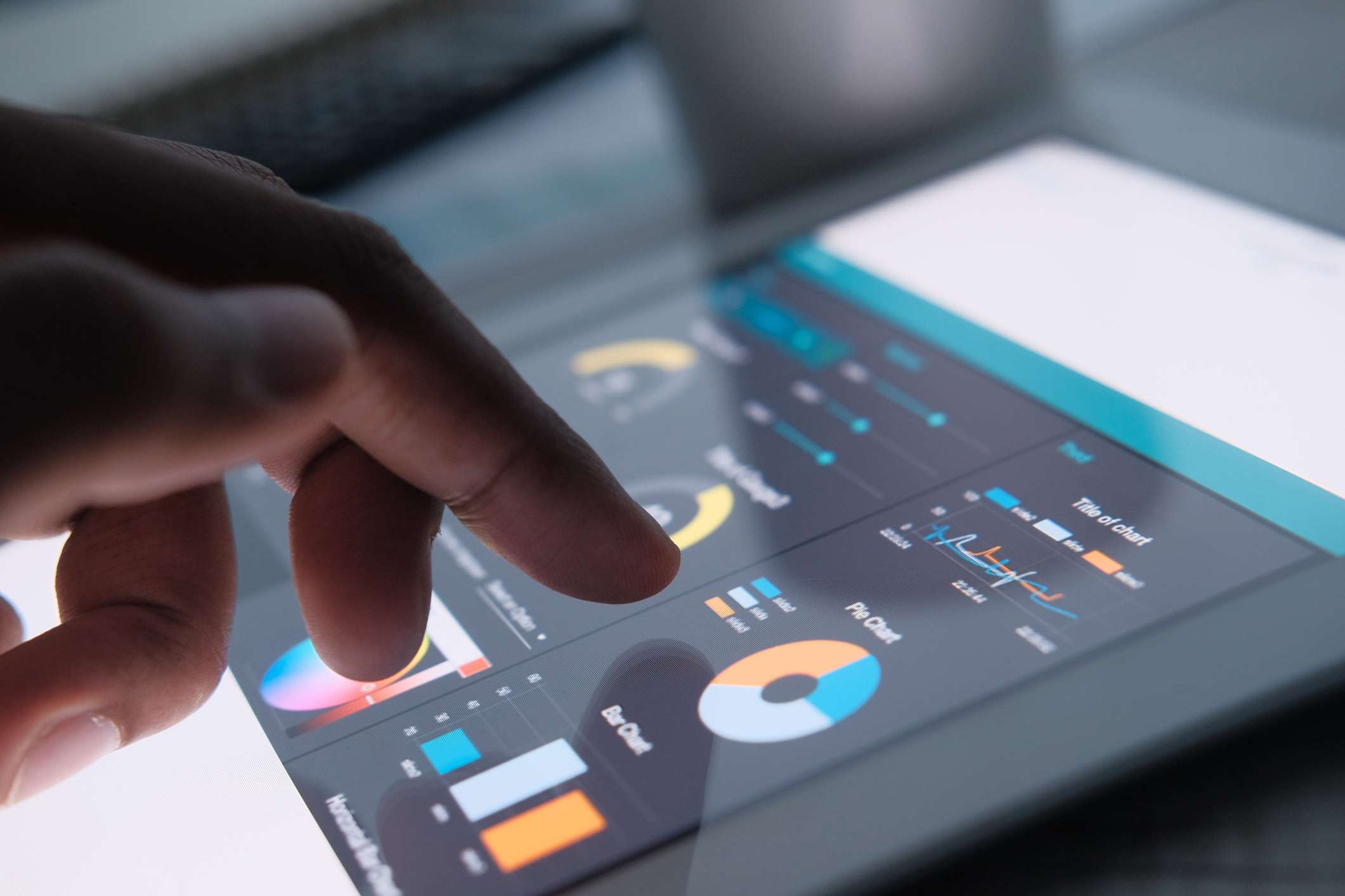 close up of man hand with digital tablet analyzing growth charts