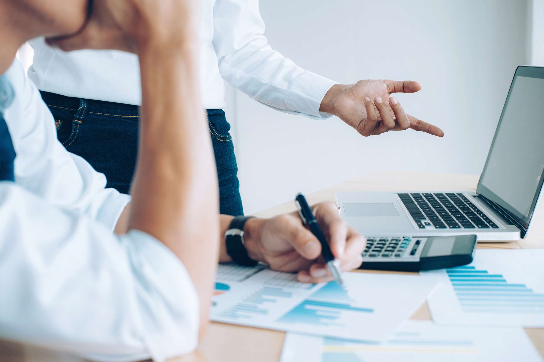 Business people analyzing documents in front of the computer.