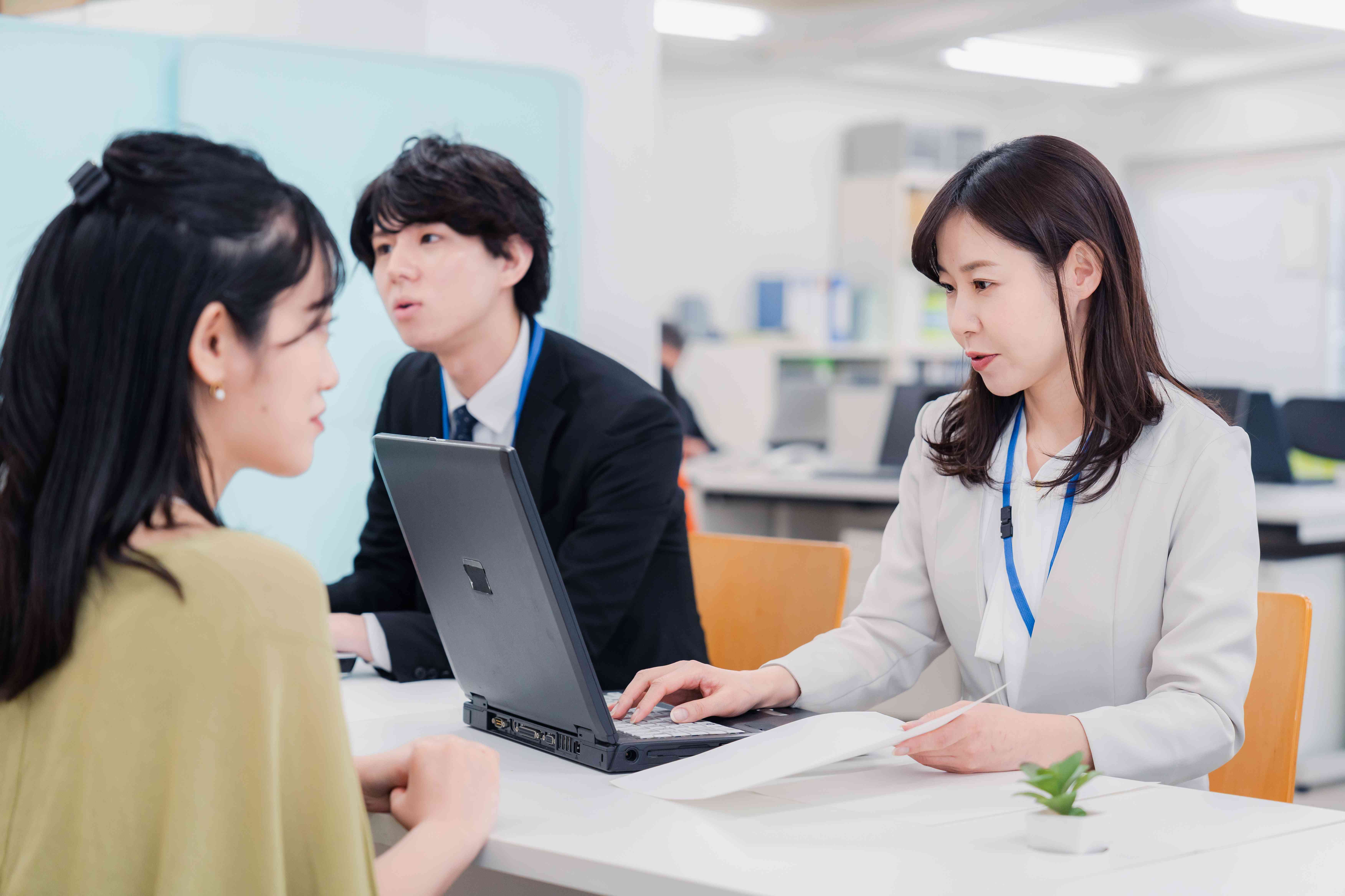 Woman bank teller answering questions from her customer