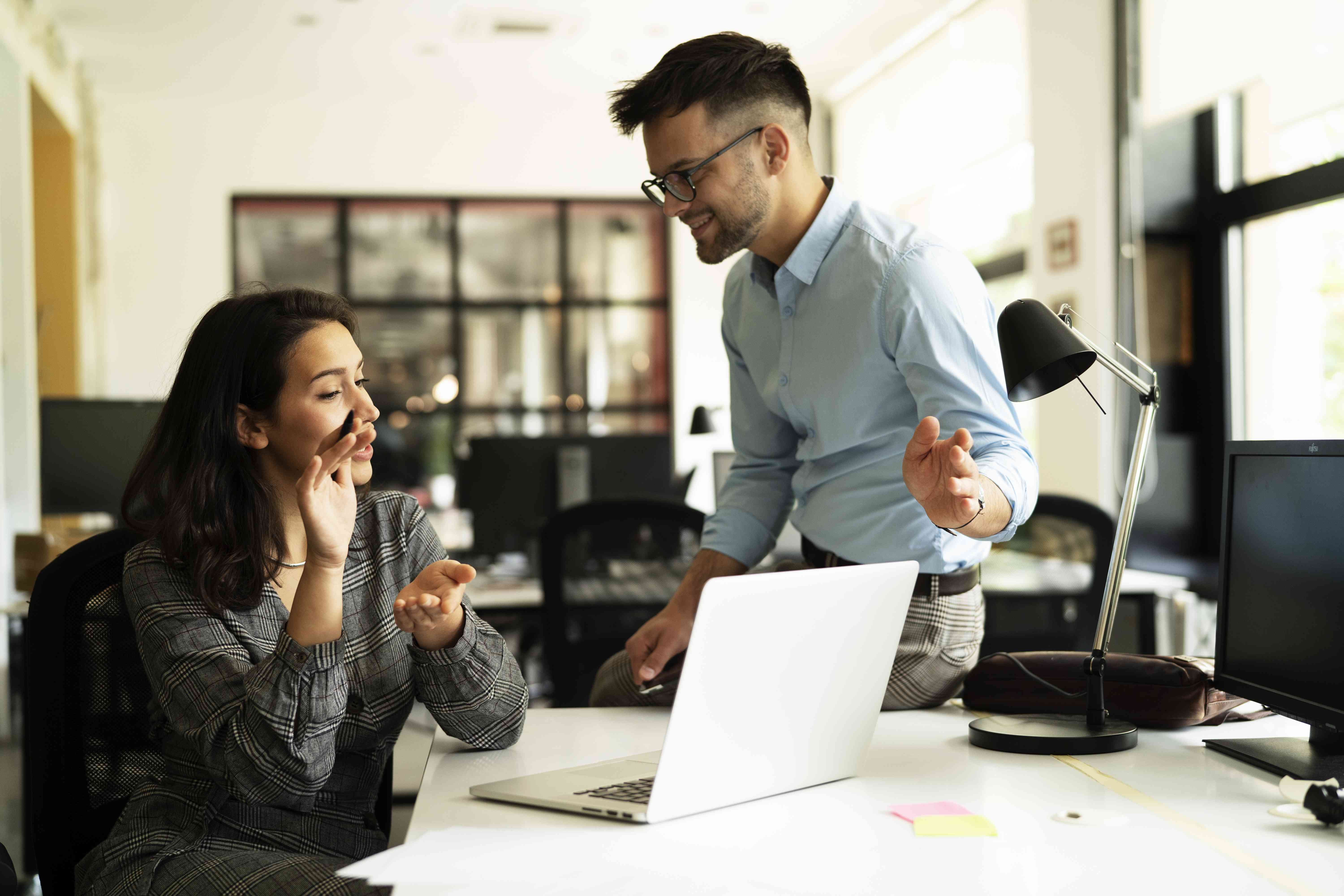 Two coworkers discussing where to put their savings in for higher interest